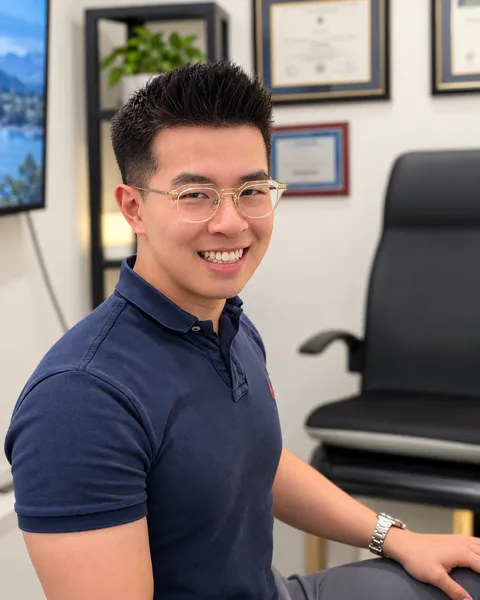 Derek Lin, OD, smiling in an exam room at Park Slope Eye